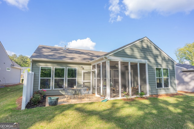 back of property featuring a sunroom, a yard, and a patio