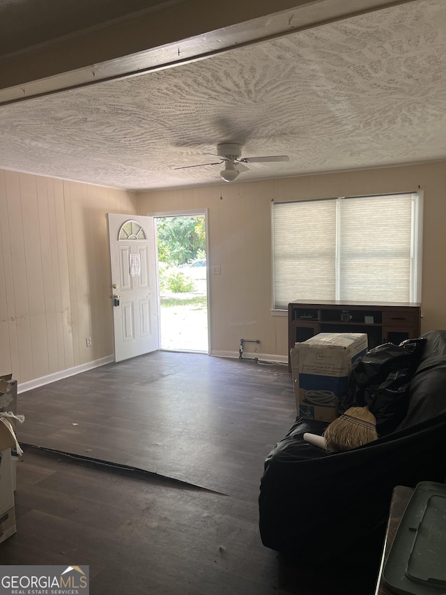 908 Crestwood Ter, Warner Robins, GA 31088 - living room featuring wood finished floors, baseboards, ceiling fan, a textured ceiling, and wooden walls