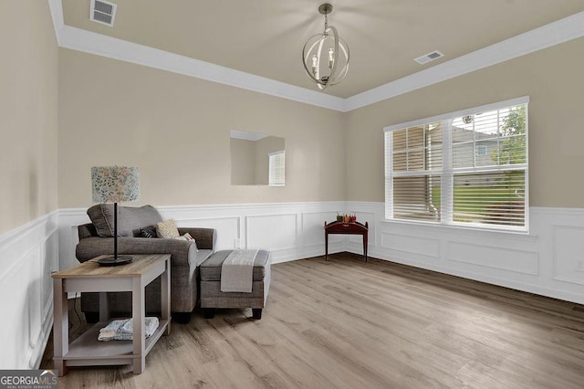 174 Crown Pointe Dr, Dawsonville, GA 30534 - sitting room featuring wainscoting, crown molding, light wood finished floors, and a decorative wall