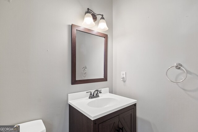 8035 Canter Ln, Alpharetta, GA 30009 - half bathroom featuring vanity and toilet