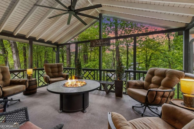 sunroom / solarium with a ceiling fan and an outdoor living space with a fire pit