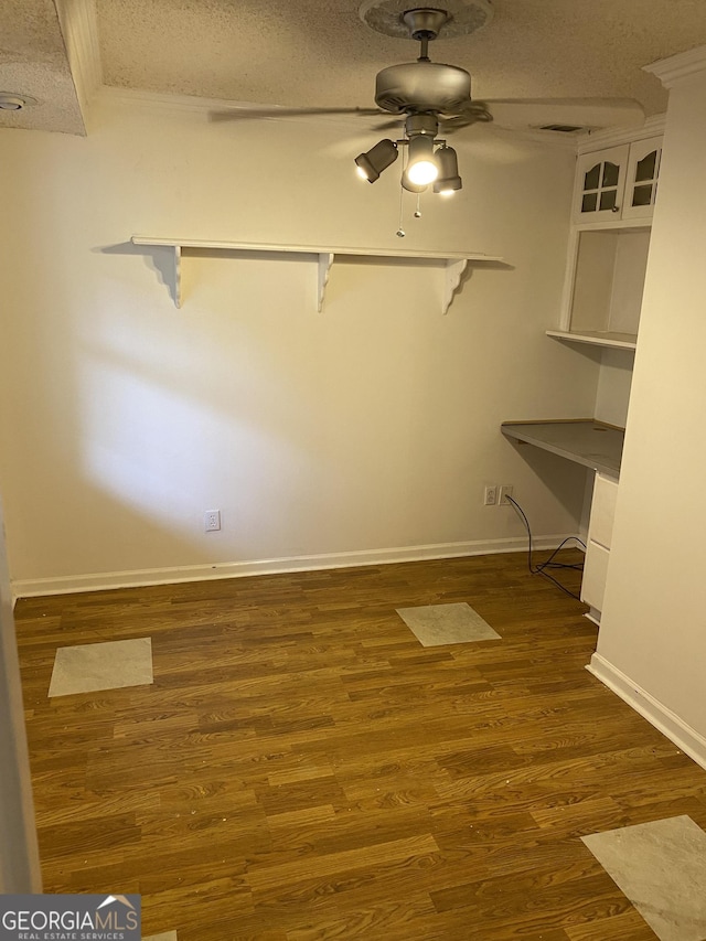 walk in closet with ceiling fan and wood finished floors