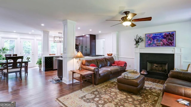 488 Mayapple Gln, Dawsonville, GA 30534 - living room featuring a ceiling fan, dark wood finished floors, decorative columns, a fireplace with flush hearth, and recessed lighting