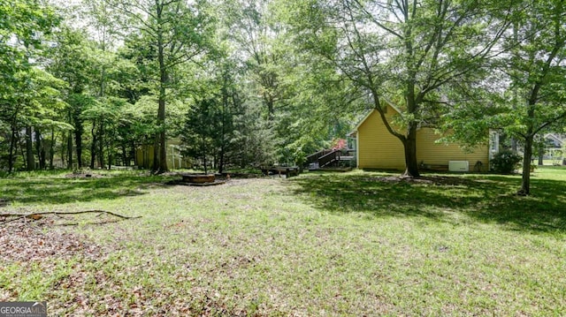 488 Mayapple Gln, Dawsonville, GA 30534 - view of green lawn featuring a fire pit