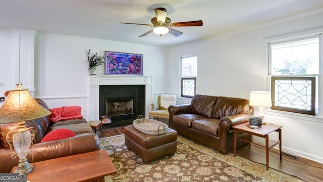 488 Mayapple Gln, Dawsonville, GA 30534 - living room featuring wood finished floors, ceiling fan, a fireplace with flush hearth, and baseboards