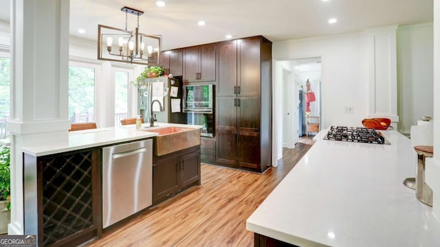 488 Mayapple Gln, Dawsonville, GA 30534 - kitchen with stainless steel appliances, a sink, light countertops, light wood-type flooring, and recessed lighting