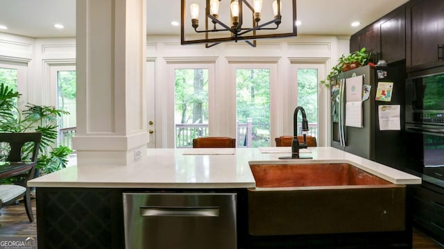 488 Mayapple Gln, Dawsonville, GA 30534 - kitchen with light countertops, a sink, dark brown cabinetry, healthy amount of natural light, and recessed lighting