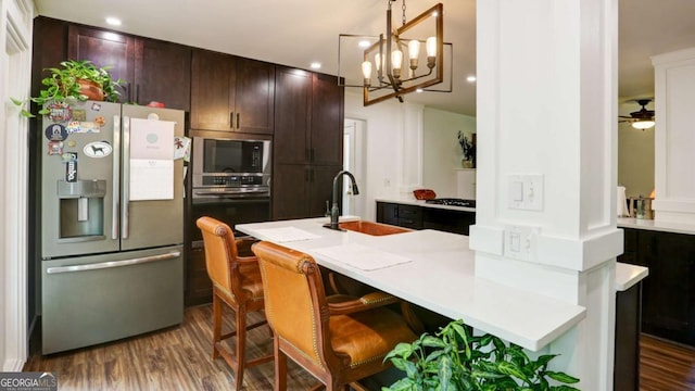488 Mayapple Gln, Dawsonville, GA 30534 - kitchen with stainless steel fridge with ice dispenser, oven, built in microwave, dark wood finished floors, and light countertops