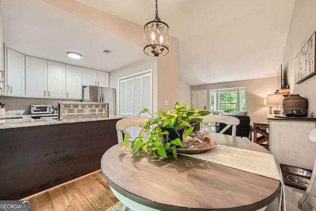 2336 Vistamont Dr, Decatur, GA 30033 - dining space with light wood finished floors and a chandelier