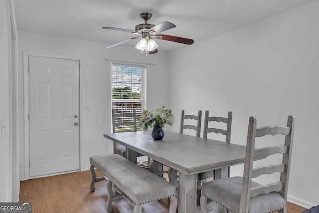 dining area with ceiling fan and light wood finished floors