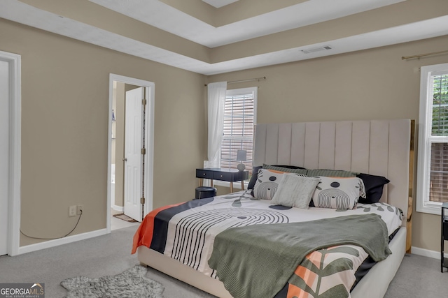 carpeted bedroom with baseboards and connected bathroom