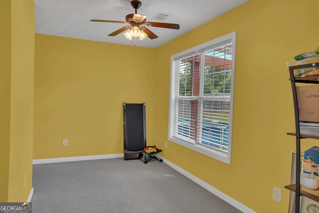 unfurnished room with baseboards, a ceiling fan, and carpet