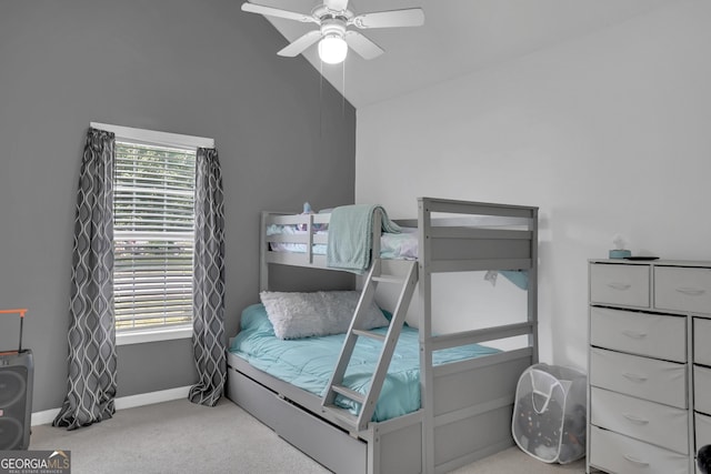 bedroom featuring carpet flooring, ceiling fan, baseboards, and high vaulted ceiling