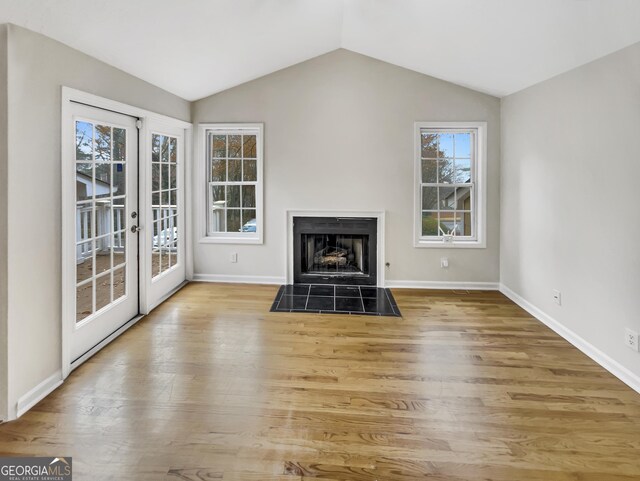 2190 River Heights Ct SE, Marietta, GA 30067 - unfurnished living room with wood finished floors, french doors, vaulted ceiling, and a fireplace