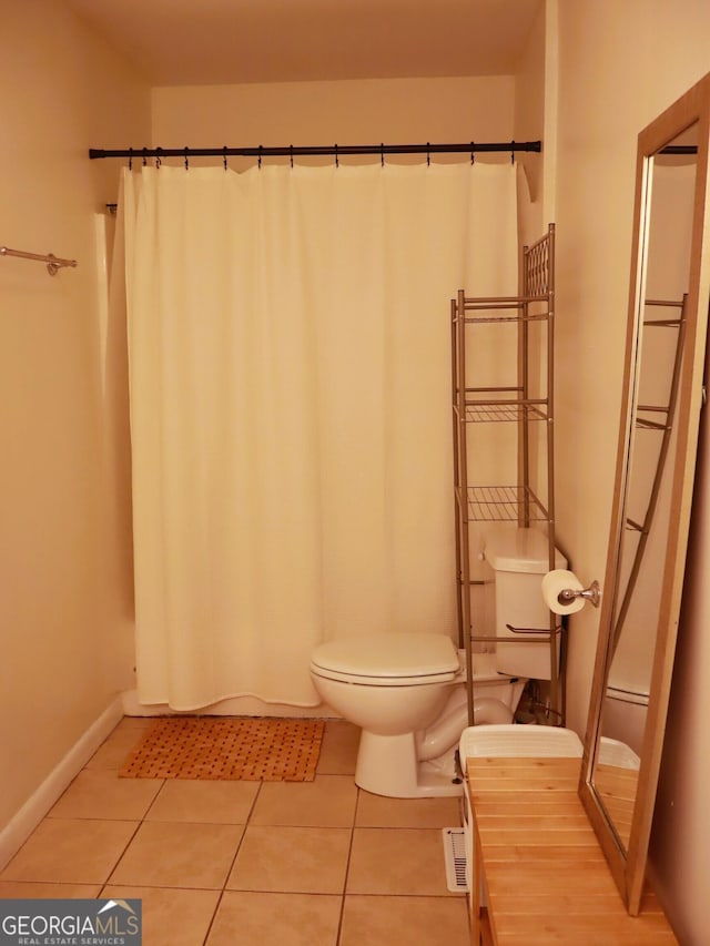1315 Walston St, Dalton, GA 30720 - bathroom with toilet, tile patterned flooring, baseboards, and a shower with curtain