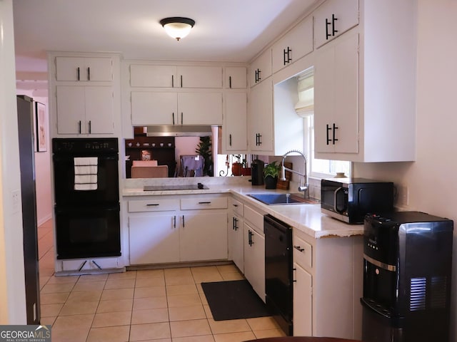 1315 Walston St, Dalton, GA 30720 - kitchen featuring black appliances, a sink, light countertops, white cabinets, and light tile patterned floors