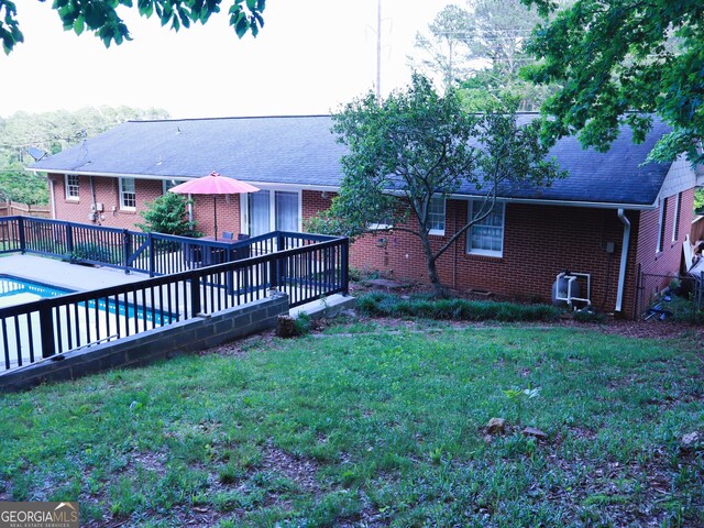 1315 Walston St, Dalton, GA 30720 - back of house with brick siding and roof with shingles