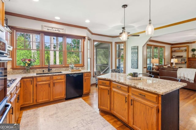 kitchen with black dishwasher, a sink, crown molding, plenty of natural light, and recessed lighting
