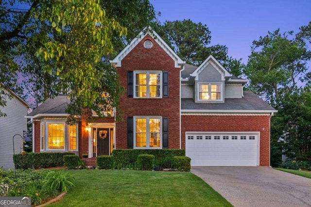 view of front of property with concrete driveway, brick siding, and a lawn