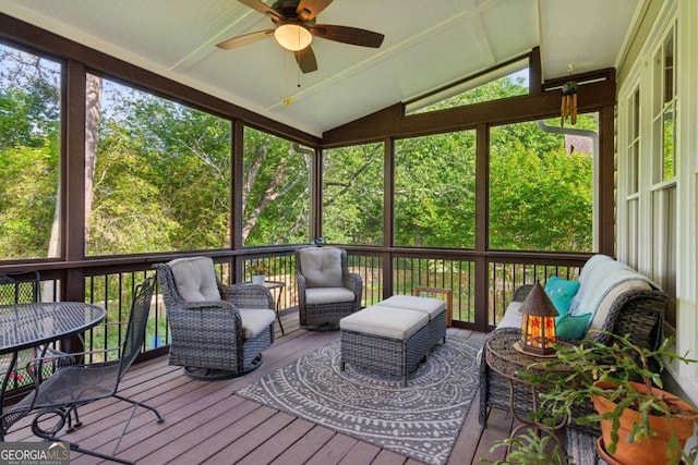 sunroom featuring a ceiling fan, lofted ceiling, and an outdoor hangout area