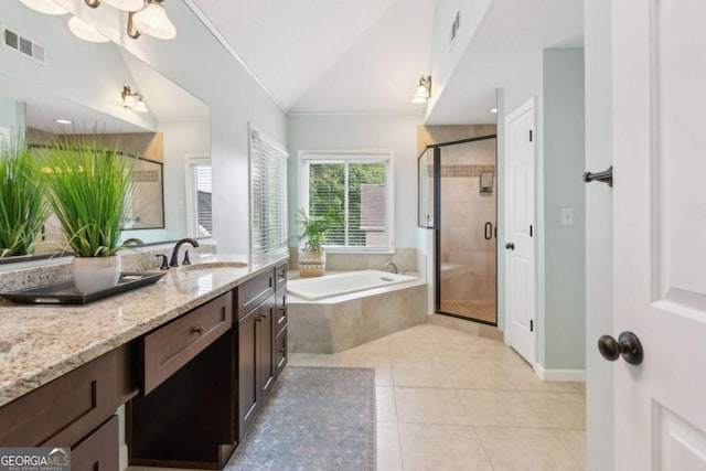 full bathroom with tile patterned flooring, a bath, a shower stall, vaulted ceiling, and vanity