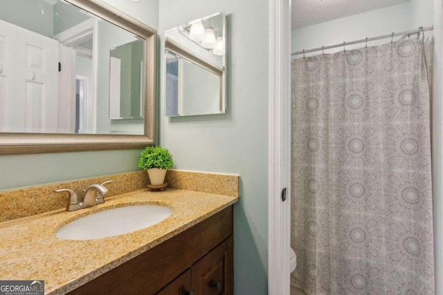 full bathroom featuring vanity, toilet, and curtained shower
