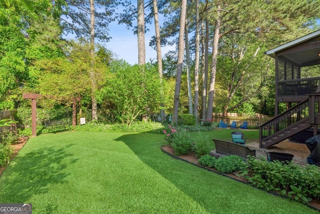 view of yard featuring stairway and a sunroom