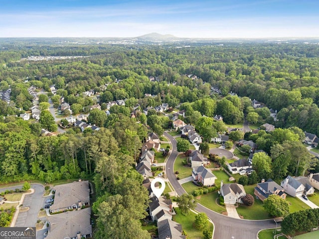 aerial perspective of suburban area with a heavily wooded area