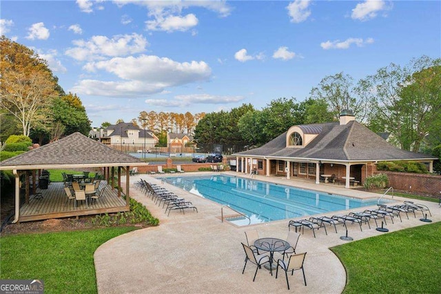community pool featuring a gazebo and a deck