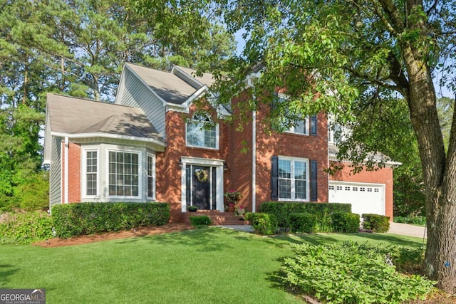 view of front of house featuring a front yard, brick siding, concrete driveway, and an attached garage
