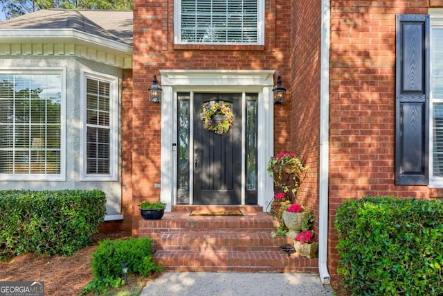 property entrance with brick siding