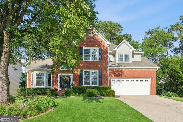 view of front of home with concrete driveway, brick siding, a front yard, and an attached garage