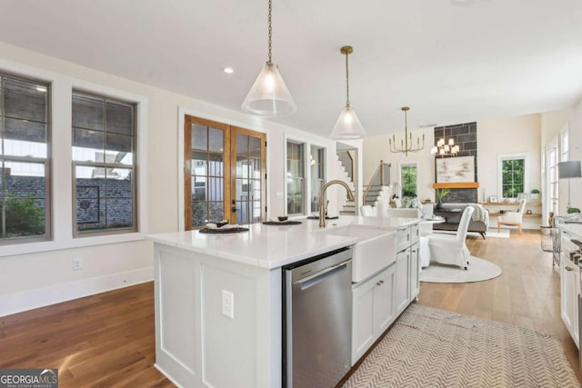 190 Arbor Garden Cir, Newnan, GA 30265 - kitchen with stainless steel dishwasher, a sink, a chandelier, wood finished floors, and recessed lighting