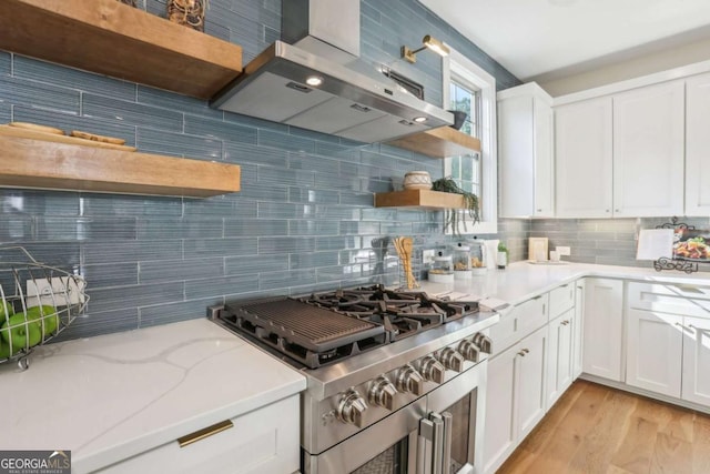 190 Arbor Garden Cir, Newnan, GA 30265 - kitchen featuring open shelves, stainless steel range, wall chimney exhaust hood, backsplash, and white cabinetry