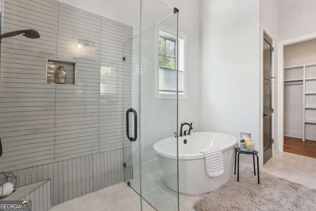 190 Arbor Garden Cir, Newnan, GA 30265 - bathroom with a shower stall, a freestanding tub, and a spacious closet