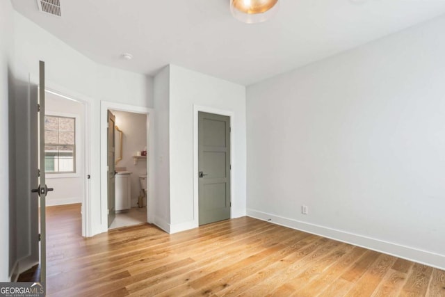 190 Arbor Garden Cir, Newnan, GA 30265 - unfurnished bedroom featuring light wood-style floors, baseboards, and connected bathroom