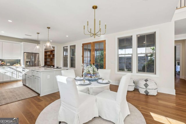 190 Arbor Garden Cir, Newnan, GA 30265 - dining space featuring a chandelier, wood finished floors, recessed lighting, and french doors