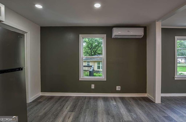 1772 Martin Pl SE, Smyrna, GA 30080 - spare room with an AC wall unit, wood finished floors, baseboards, and recessed lighting