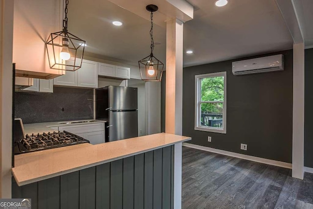 1772 Martin Pl SE, Smyrna, GA 30080 - kitchen with freestanding refrigerator, a wall unit AC, backsplash, white cabinetry, and dark wood-style flooring