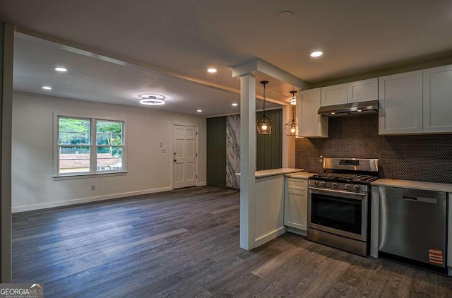 1772 Martin Pl SE, Smyrna, GA 30080 - kitchen featuring stainless steel appliances, under cabinet range hood, dark wood-style flooring, light countertops, and baseboards