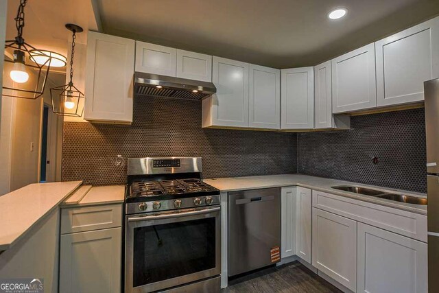 1772 Martin Pl SE, Smyrna, GA 30080 - kitchen featuring appliances with stainless steel finishes, under cabinet range hood, light countertops, backsplash, and recessed lighting