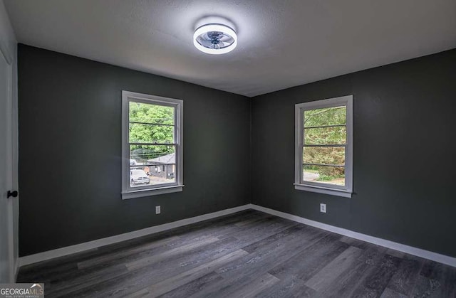 1772 Martin Pl SE, Smyrna, GA 30080 - empty room featuring healthy amount of natural light, dark wood-style flooring, and baseboards
