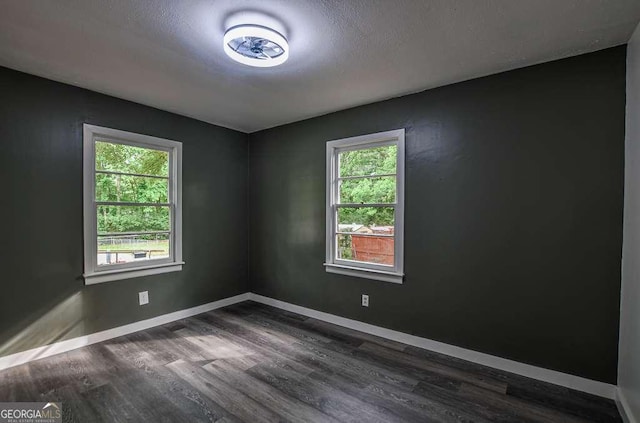 1772 Martin Pl SE, Smyrna, GA 30080 - spare room featuring dark wood-type flooring, baseboards, and a textured ceiling