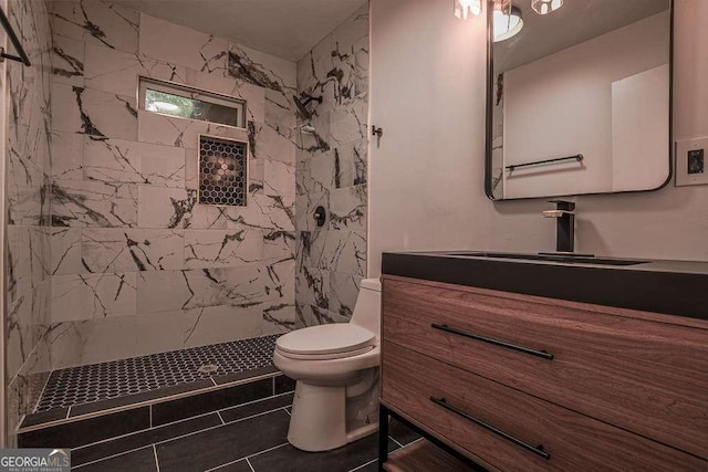 1772 Martin Pl SE, Smyrna, GA 30080 - bathroom featuring a tile shower, toilet, vanity, and tile patterned flooring