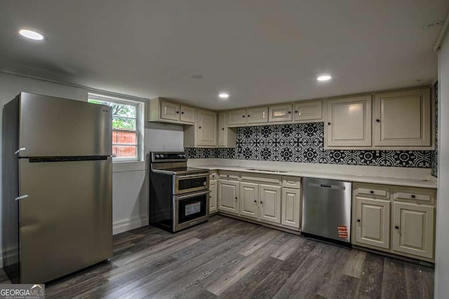 1772 Martin Pl SE, Smyrna, GA 30080 - kitchen with appliances with stainless steel finishes, dark wood finished floors, light countertops, a sink, and decorative backsplash