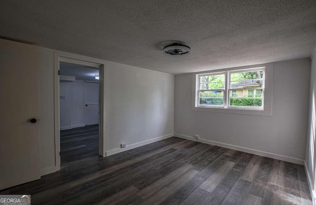1772 Martin Pl SE, Smyrna, GA 30080 - empty room featuring a textured ceiling, dark wood-type flooring, and baseboards