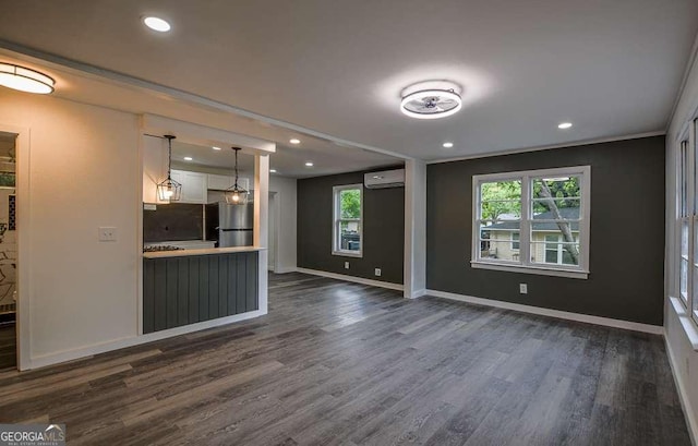 1772 Martin Pl SE, Smyrna, GA 30080 - unfurnished living room featuring an AC wall unit, dark wood-type flooring, recessed lighting, and baseboards