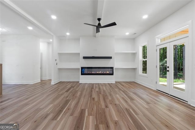 5567 Tyree Rd, Winston, GA 30187 - unfurnished living room featuring a ceiling fan, wood finished floors, recessed lighting, a glass covered fireplace, and built in features