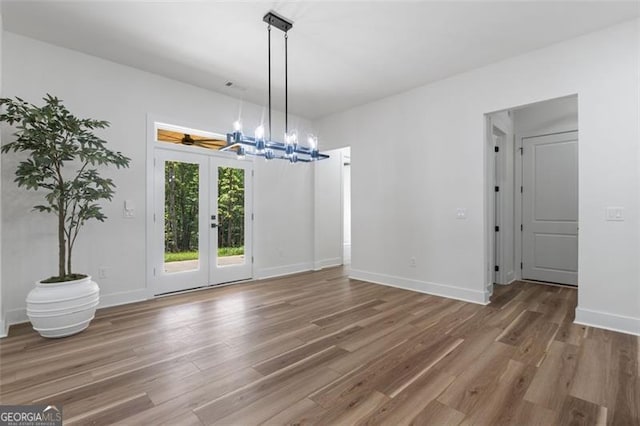 5567 Tyree Rd, Winston, GA 30187 - unfurnished dining area with a chandelier, wood finished floors, and french doors