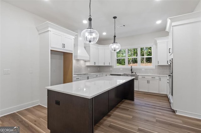 5567 Tyree Rd, Winston, GA 30187 - kitchen featuring decorative backsplash, a kitchen island, light countertops, recessed lighting, and dark wood-style flooring